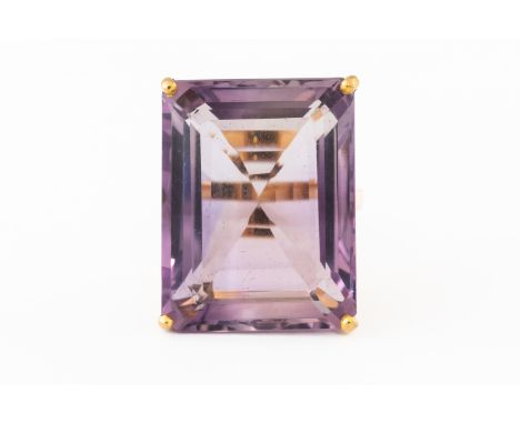 A LARGE AMETHYST SINGLE STONE RINGClaw set with an emerald cut amethyst weighing an estimated 27.6 carats, ring size O½, unma