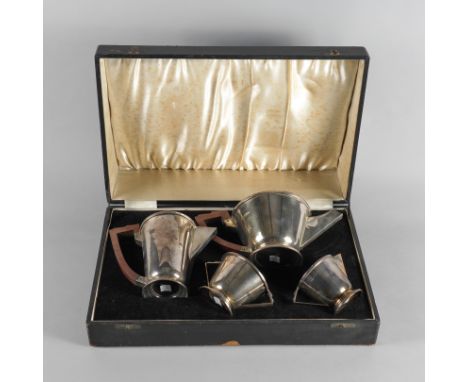 AN ART DECO SILVER FOUR PIECE TEA SETComprising a teapot, a hot water jug, a twin handled sugar bowl and a milk jug, the larg