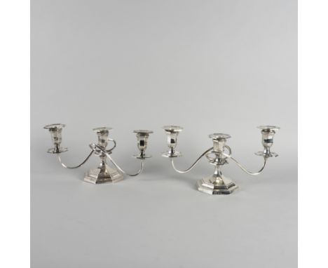A PAIR OF SILVER SQUAT THREE LIGHT TABLE CANDELABRAEach raised on a swept octagonal foot, Birmingham  probably 1938, height 1