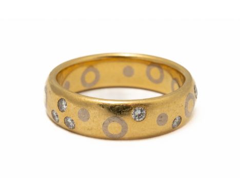 A DAVID ASHTON 18CT GOLD AND DIAMOND BAND RINGMounted with circular cut diamonds in an abstract design and with white gold ci