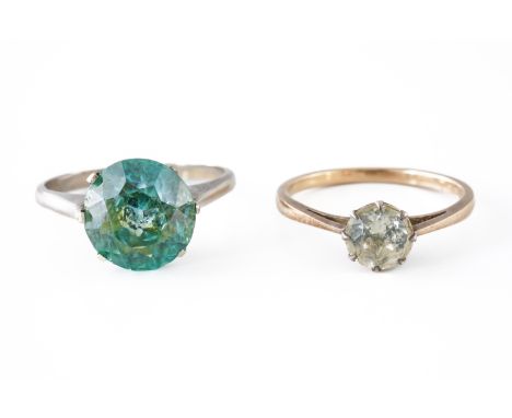 A BLUE ZIRCON SINGLE STONE RING AND ANOTHER RING (2)The first ring claw set with a circular cut blue zircon, unmarked, ring s