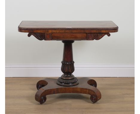A REGENCY ROSEWOOD FOLDOVER CARD TABLEOn turned column over quatrefoil base, 92cm wide; 45cm deep; 74cm high