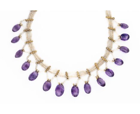 AN AMETHYST AND SEED PEARL GRADUATED COLLAR NECKLACEThe three row seed pearl necklace with a row of graduated oval amethyst d