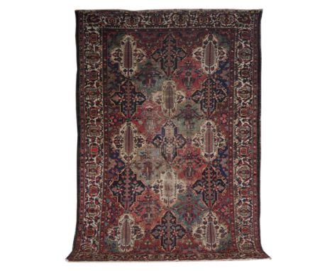 A BAKHTIARI CARPET, PERSIANThe interlocking tile design with trees, flower heads and plants in a variety of colours; an ivory
