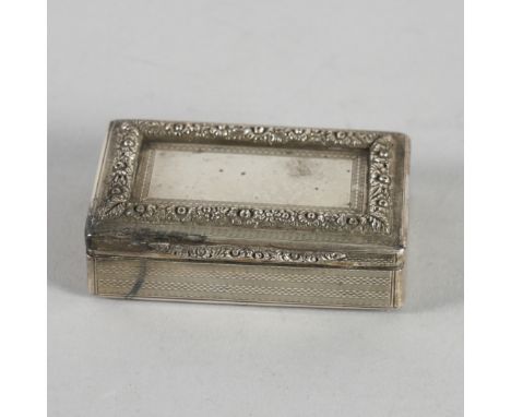 A SILVER RECTANGULAR SNUFF BOXGilt within, the exterior engine turned, the hinged lid with a raised floral and foliate border