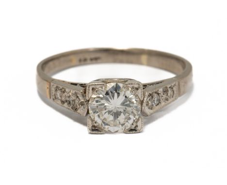 A WHITE GOLD AND DIAMOND RINGMounted with the principal circular cut diamonds in a square shaped setting, between diamond two