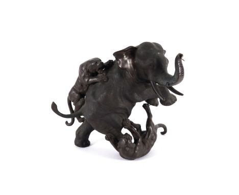 A JAPANESE PATINATED BRONZE ANIMALIER GROUP OF TIGERS ATTACKING AN ELEPHANTMeiji Period (1868-1912)  Modelled rearing up (som