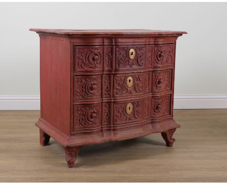 A 19TH CENTURY CONTINENTAL RED PAINTED OAK THREE DRAWER COMMODEWith carved drawer fronts, 102cm wide; 62cm deep; 88cm high