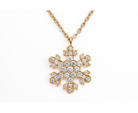 A GOLD AND DIAMOND PENDANT NECKLACE IN A HEXAGONAL SNOWFLAKE DESIGNThe pendant mounted with round brilliant cut diamonds, det