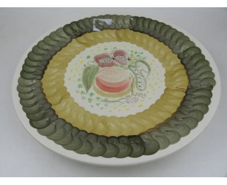 A large Susie Cooper charger, decorated with fruit within green and umber bands, the reverse bearing signature, D. 37cm