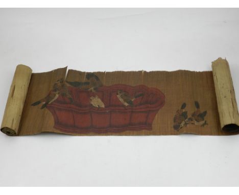 A Chinese scroll, decorated with birds feeding, bears Chinese verse. 