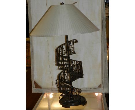 A spiral staircase table lamp, having cream shade. H: 33cm