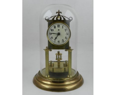An early 20th century brass anniversary clock, the enamel dial with Arabic numerals and outer minute track, raised on a circu