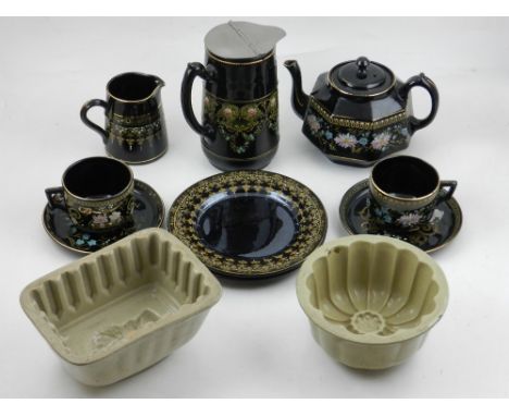 An early 20th century tea service for two including milk and cream jugs, together with two jelly moulds, (qty). 