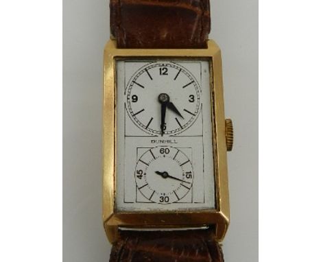 Alfred Dunhill, England. An Art Deco 18ct gold duo-dial doctor's watch, set on a leather lizard skin strap.