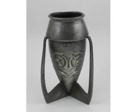 A pewter vade, in the manner of Achibald Knox for Liberty, of torpedo form with a band of stylised flowers on a tripod base, 