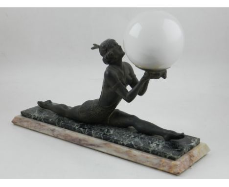 An Art Deco table lamp, modelled in the form of an athletic woman holding a ball, mounted on a marble base, W. 39cm.