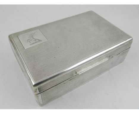 A rectangular silver cigarette box, hallmarked Mappin & Webb, wood lined, having engine turned finish. 