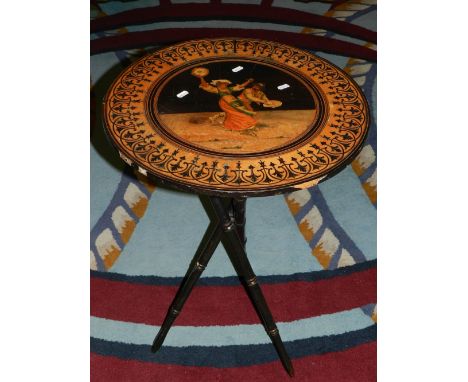 A late 19th century Sorrento inlaid ebonised circular wine table, the top depicting a couple dancing with instruments, raised