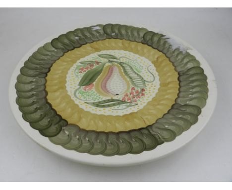 A large Susie Cooper charger, decorated with a pear within green and umber bands, the reverse bearing signature. D. 37cm