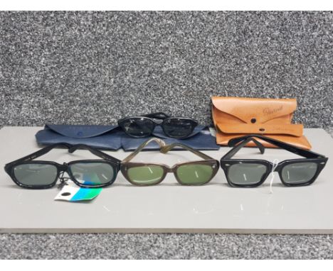 Four pairs of vintage Polaroid sunglasses with cases