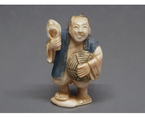 An early 20th century carved ivory netsuke of man, signed.