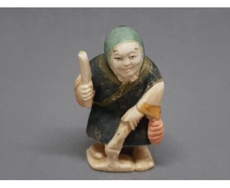 An early 20th century carved ivory netsuke of an elderly woman, signed.