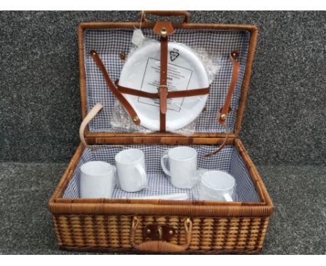 Vintage wicker picnic hamper containing plastic cups, plates &amp; cutlery