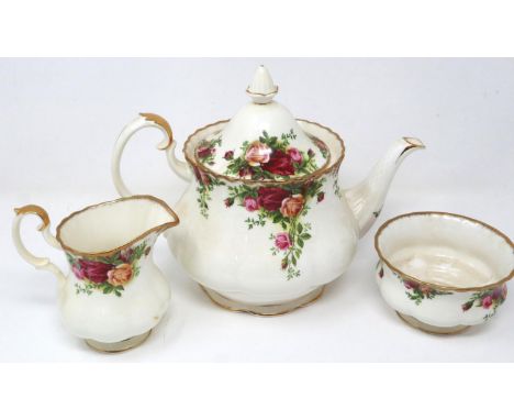 Royal Albert Old Country Roses tea service comprising teapot, cream and sugar, with 1962 date, no cracks or chips, some wear 