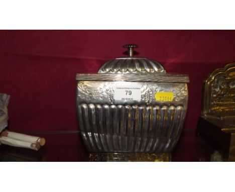 A white metal half fluted tea caddy