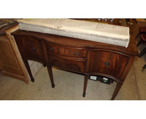 A mahogany twin pillar extending dining table with one extra leaf and matching sideboard by Maple and Co.