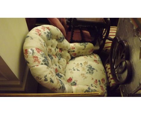 A floral upholstered button back armchair 