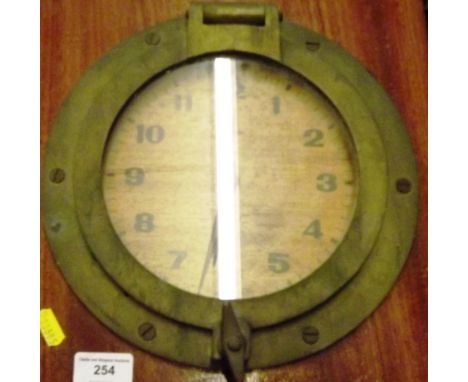 A vintage brass ship porthole clock