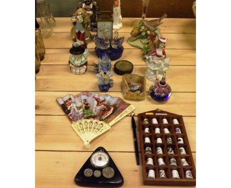 A collection of porcelain thimbles; a mantel clock; various decorative ornaments; a fan etc.