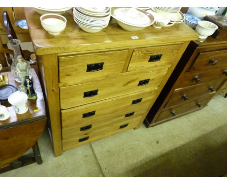 A light oak chest fitted two short over four long drawers