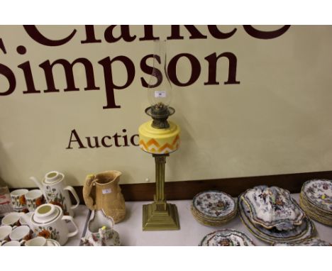 An Art Deco brass and coloured glass oil lamp