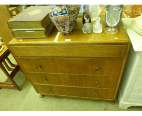 A light oak Art Deco chest, the top blind drawer fitted with a mirror, and three long drawers under 