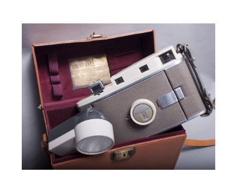 A Presentation Polaroid Land Camera, 800 Model together with wink light flash unit, in tan leather case with plaque on inside