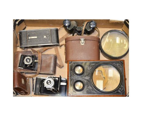 An Assortment of Optical Equipment and Folding Cameras,  Including a decorative stereo card viewer, a Condenser Lens, a pair 