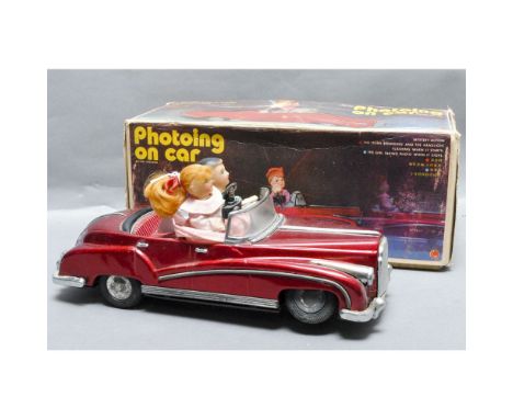 Photoing on Car, tinplate battery operated toy car with lady taking photograph when it comes to a stop, Chinese, in original 