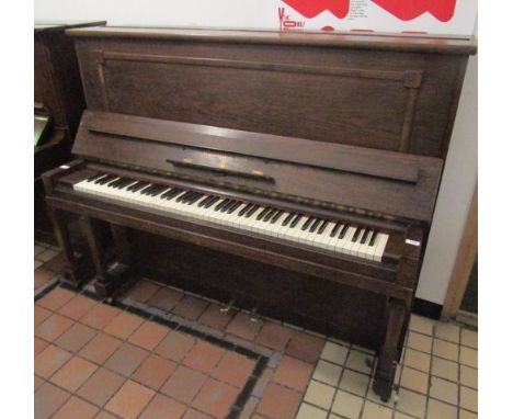 Steinway (c1927) A Model K upright piano in an oak case.