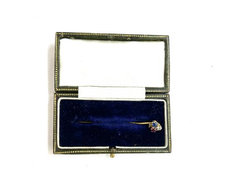 Unmarked high carat gold diamond ruby and sapphire stick pin in the shape of a club 1.8 grams in fitted case 