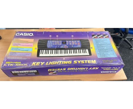 Boxed Casio 100 song bank keyboard, ctk-560l key lighting system and stand 