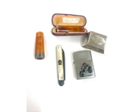 Two amber cheroot/ cigar holder and a zippo lighter and silver fruit knife 