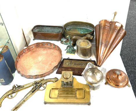 Selection of brass and copper ware includes a lion ended planter, novelty umbrella stand, dog nut cracker, desk ink stand etc
