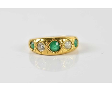 An 18ct yellow gold five stone diamond and emerald graduated ring, size K 1/2, approx 4.6g.