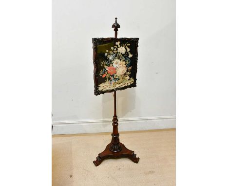 A Victorian mahogany firescreen, with domed top above the tapestry panel, on a tripod base, height 150cm.