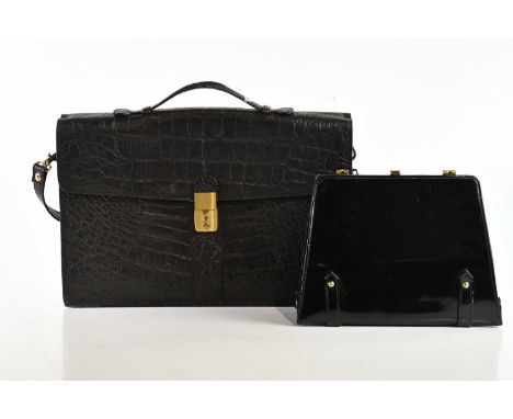 A black vintage crocodile skin briefcase with brass tone hardware front lock, detachable shoulder strap, top handle, three in