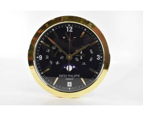 A 'Patek Philippe' dealer's display wall clock, with faux subsidiary dials and date aperture, battery operated movement, diam