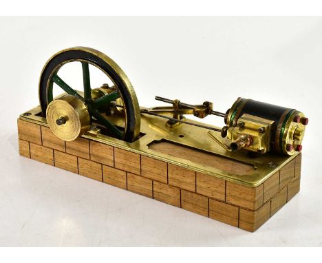 A brass scratch built live steam single piston engine, on wooden plinth, length 28cm. 